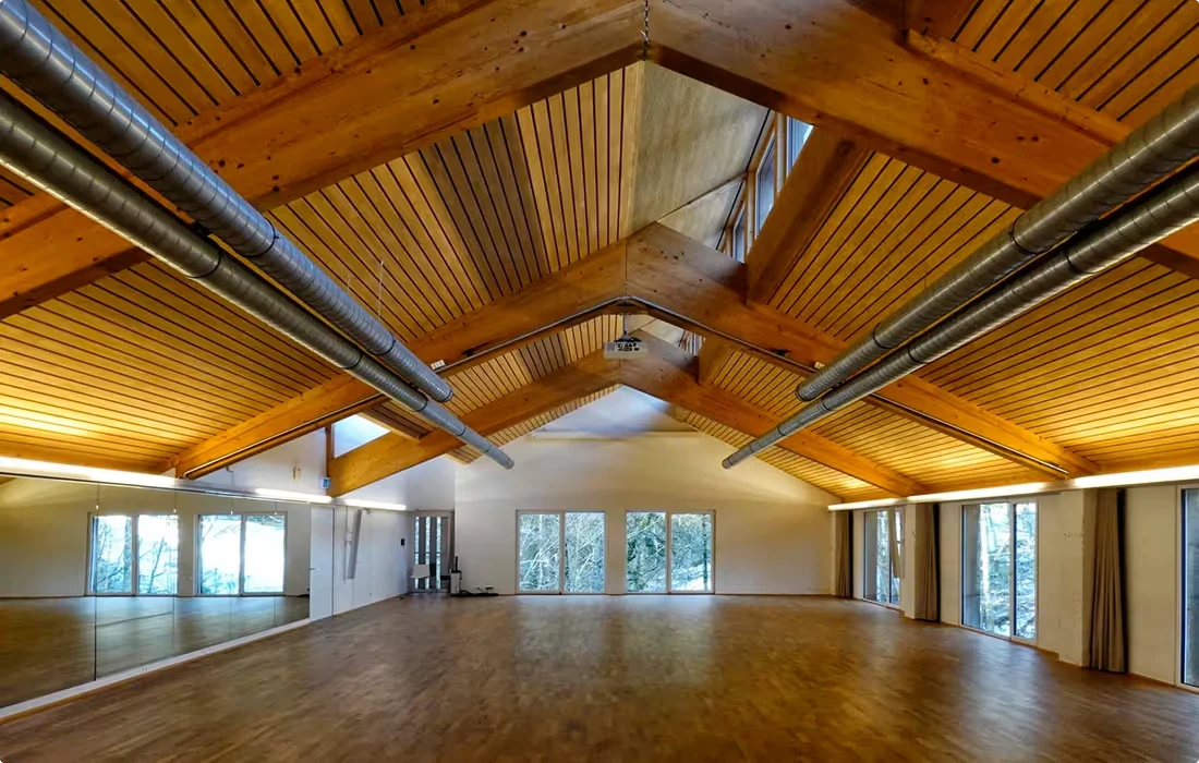 Flow60 dance hall — another view of the light-filled wooden space with high timber beams